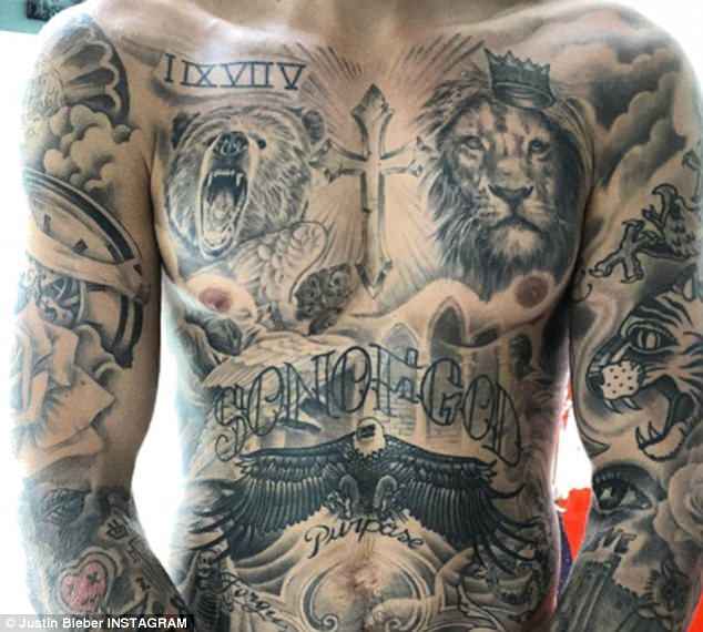 Justin Bieber flaunts heavily tattooed chest as he reveals he’s spent ‘over 100 hours’ getting inked